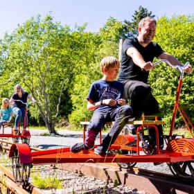 Children and adults on railway velocipedes in Aabenraa