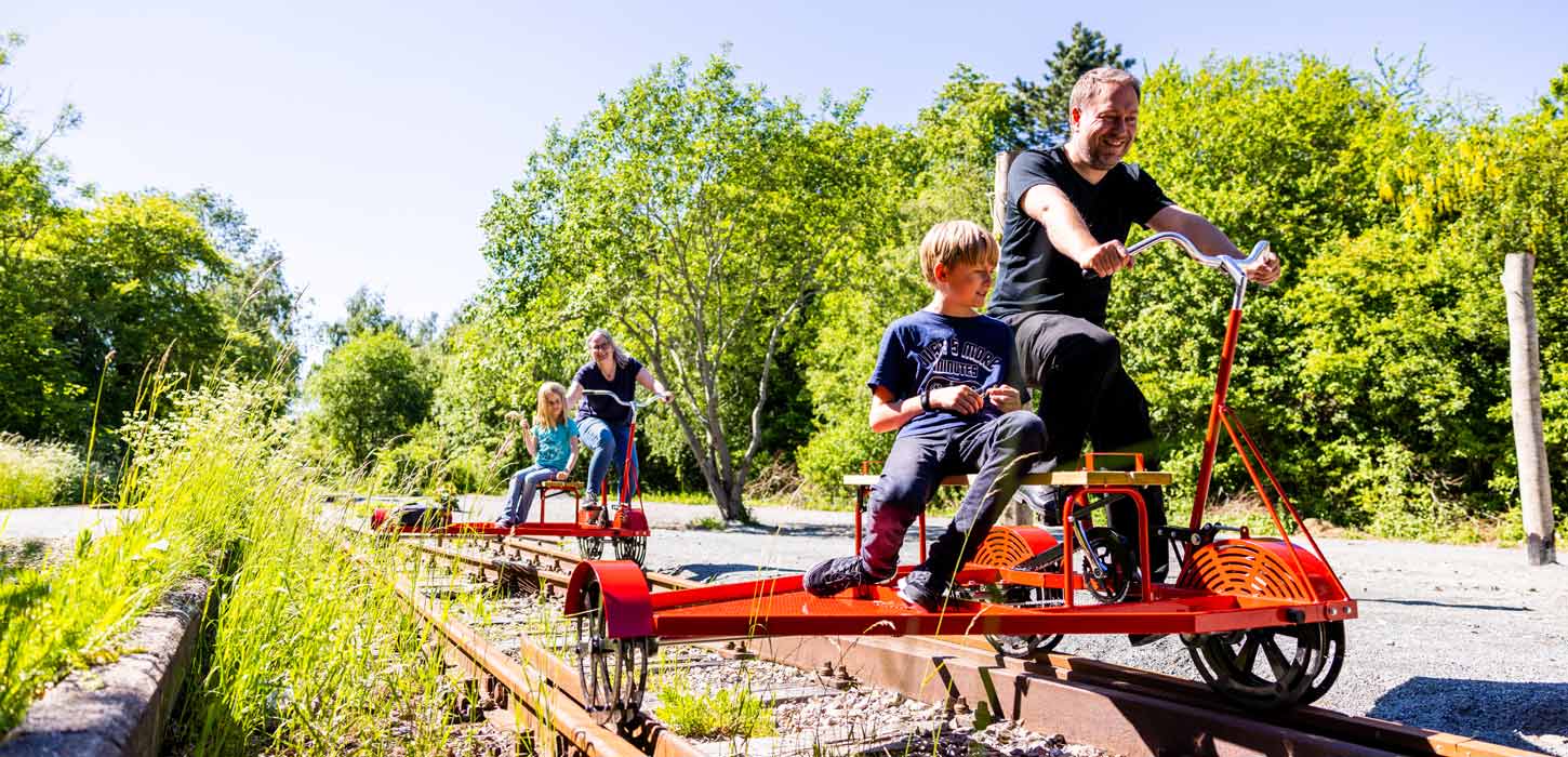 Children and adults on railway velocipedes in Aabenraa