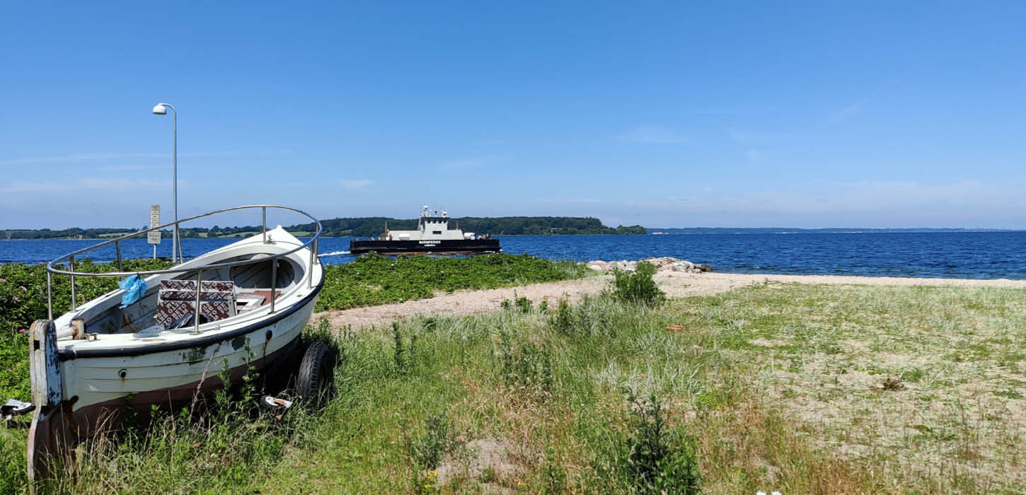 Barsø - boat on the beach and ferry in the background