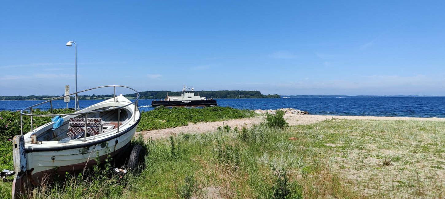 Barsø - boat on the beach and ferry in the background