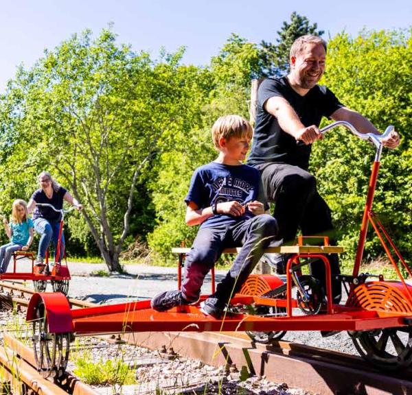 Children and adults on railway velocipedes in Aabenraa