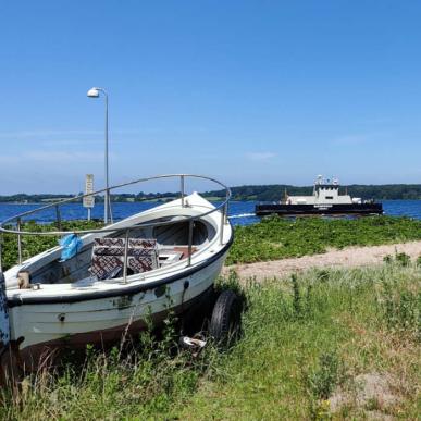 Barsø - boat on the beach and ferry in the background